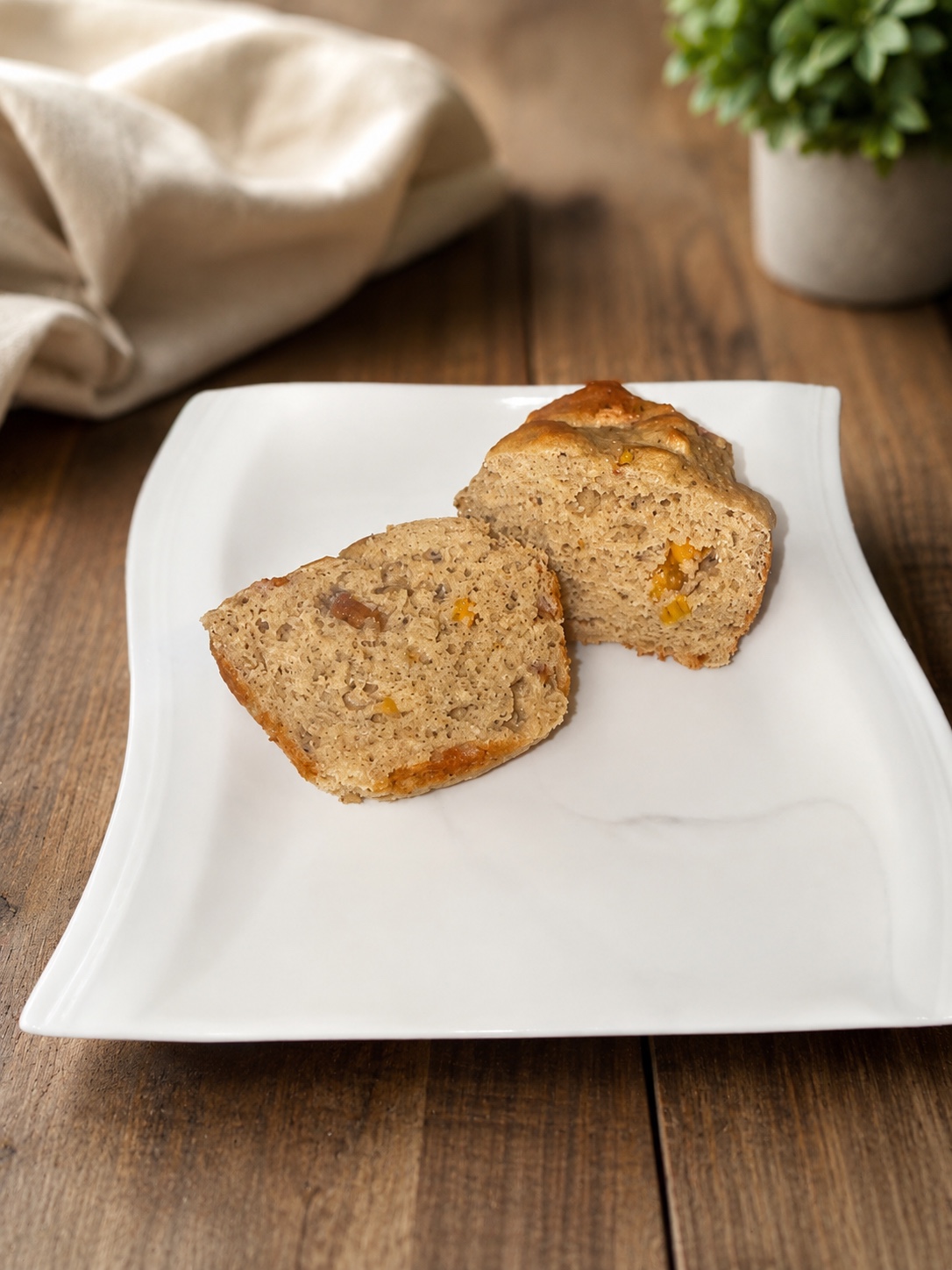 Banana peach protein jumbo muffin cut open to show the crumb and peach pieces